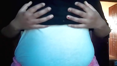 A brunette masturbates on a bed in homemade solo video