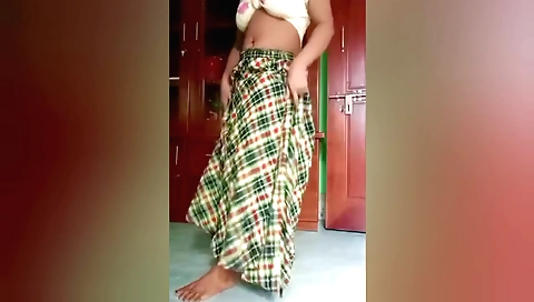 Busty indian girl in a sexy dress dances in her bedroom