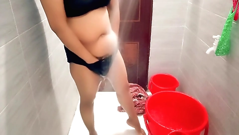 Indian housewife in her bedroom showering and rubbing her body
