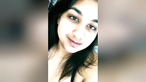 Busty brunette in a bikini and stockings shows her body