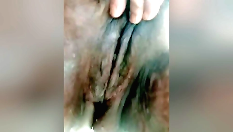 I'm masturbating my clit on the bed in this solo porn video